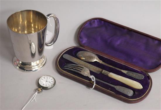 A silver Christening set, comprising knife, fork and spoon, a plated mug and a silver open face pocket watch,